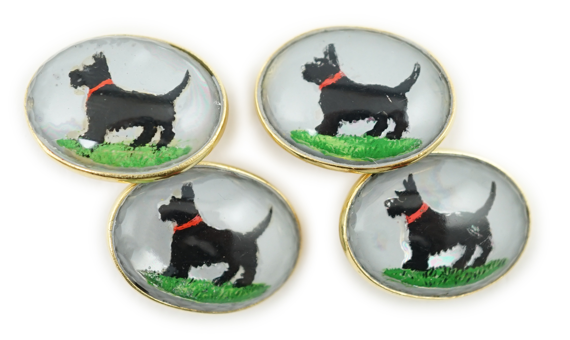 A pair of early to mid 20th century gold and Essex crystal set oval cufflinks, each decorated with a Scottie dog, 20mm, gross weight 23.4 grams. Condition - fair